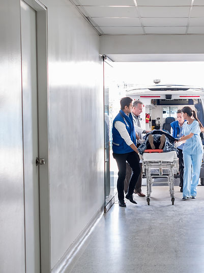 Medical team transporting a patient through a hospital corridor